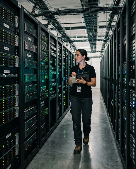 Infrastructure engineer in a data center aisle